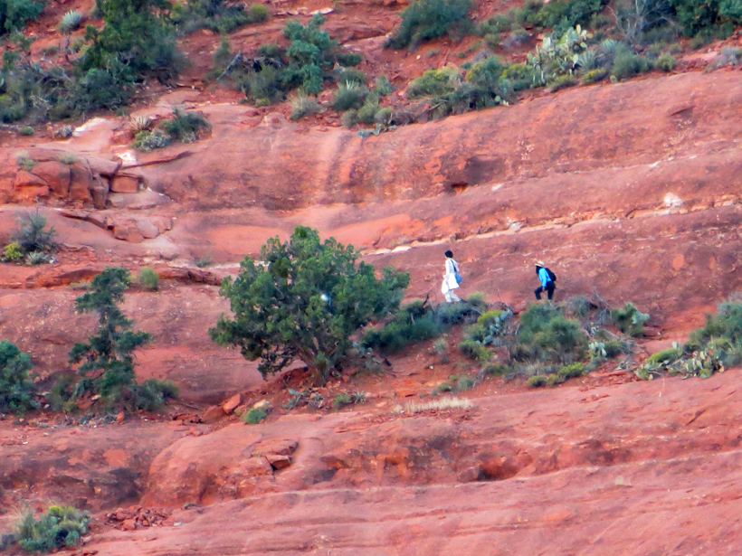Hikers along the narrow dirt path