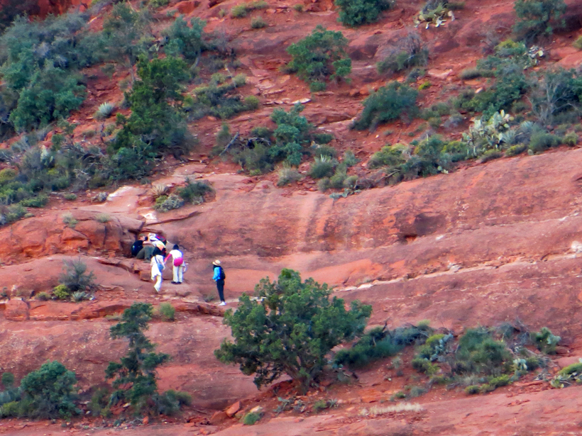 Hikers along the narrow dirt path