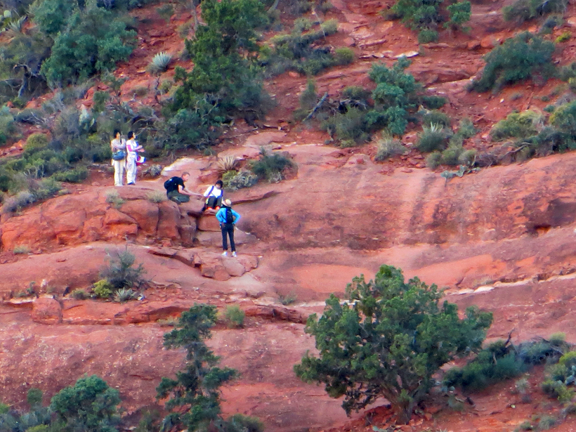 Hikers at the base of the 10 foot rock climb